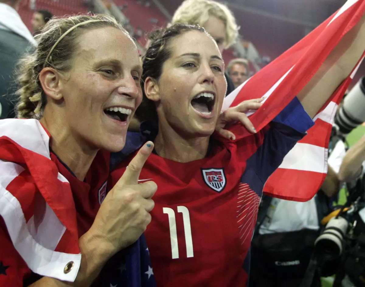 U.S. midfielder and captain Julie Foudy, right, and teammate Kristine Lilly celebrate after winning the 2004 Olympic gold medal in Athens.