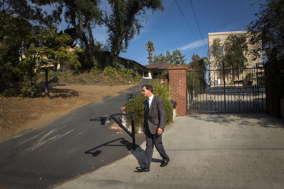 Preservation advocate Robert Cherno walks on the street outside Chinese American architect Gilbert L. Leong's Tirado House in Silver Lake.
