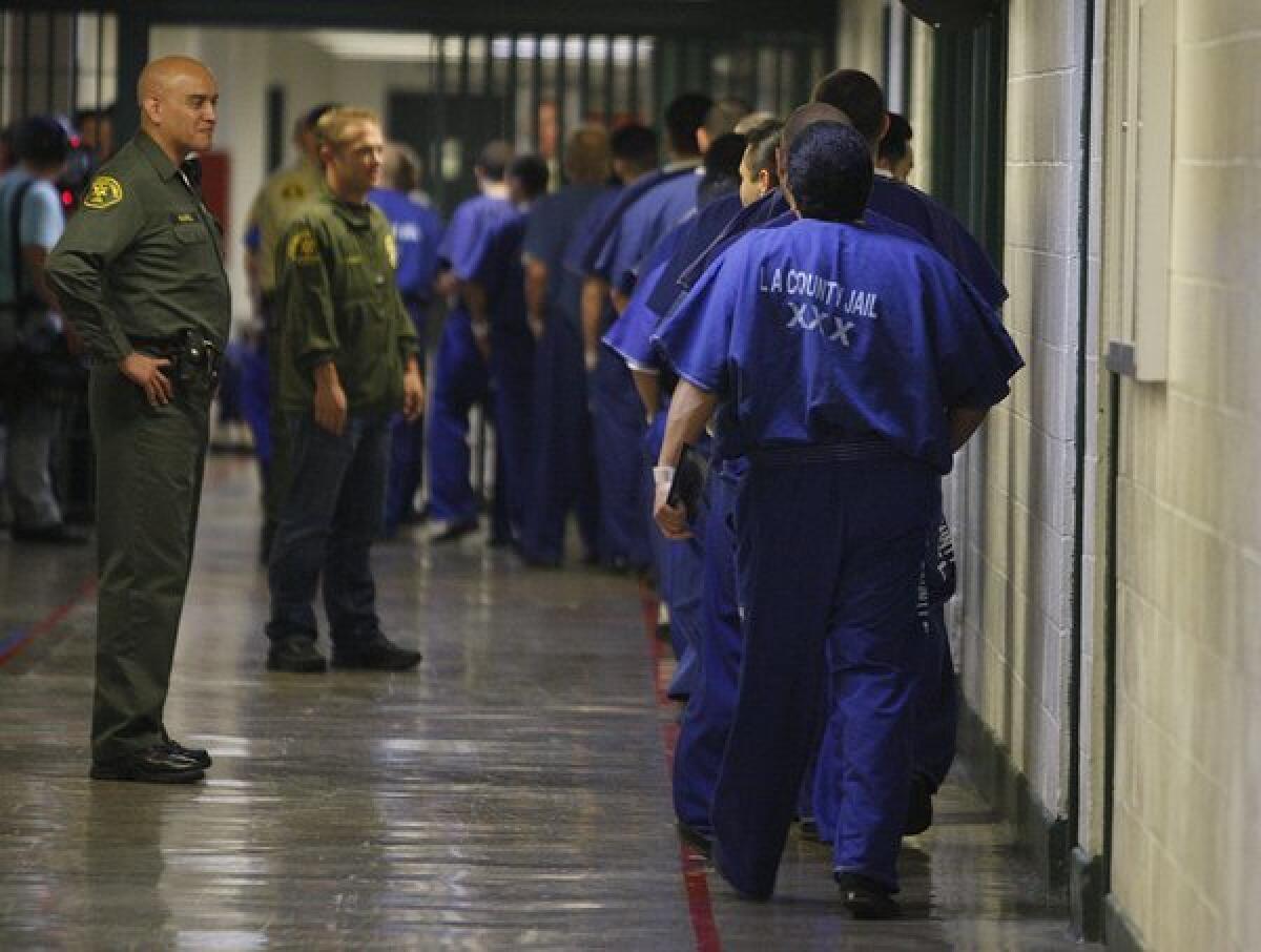 Inmates are watched by members of the Los Angeles County Sheriff's Department at the Men's Central Jail in Los Angeles in 2012.
