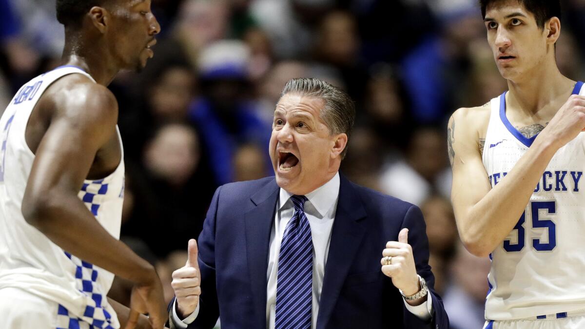 Kentucky Coach John Calipari talks strategy with Edrice Adebayo, left, and Derek Willis during the first half of their SEC tournament game against Alabama on March 11.