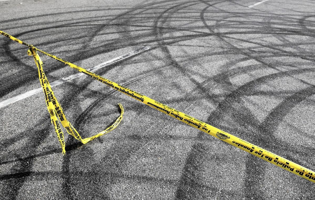 Police tape and skid marks at the scene of a fatal street race in Chatsworth.