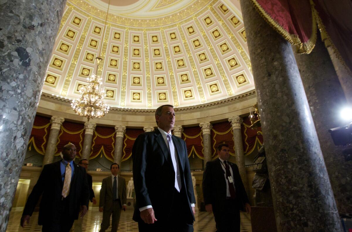 House Speaker John A. Boehner (R-Ohio) walks to the House Floor at the Capitol. Republican lawmakers continued their assault on the Affordable Care Act, voting to delay implementation of President Obama's signature healthcare law.