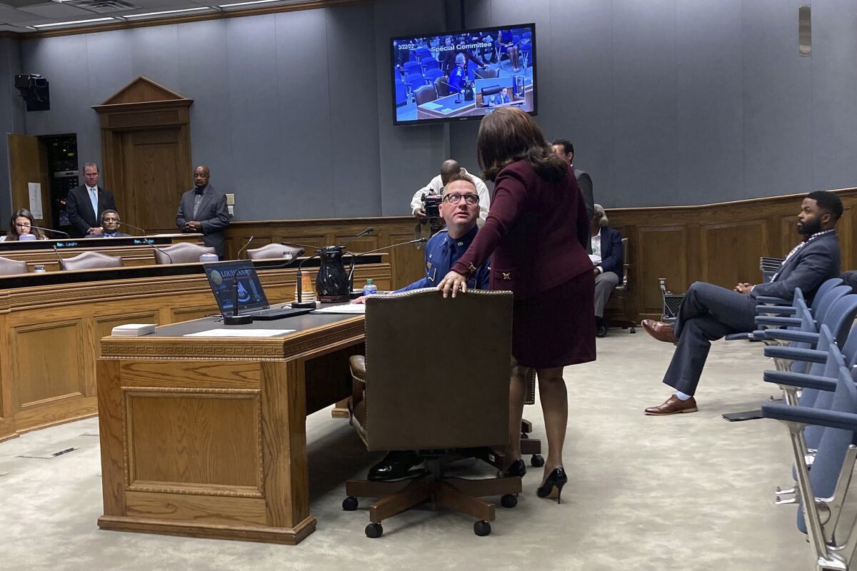 Louisiana State Police Lt. Col. Doug Cain, the agency’s second in command, confers with Gail Holland, a Louisiana State Police attorney, while testifying Tuesday, March 22, 2022, in Baton Rouge, La., before a legislative panel conducting an "all-levels" probe into the fatal 2019 arrest of Black motorist Ronald Greene. (AP Photo/Jim Mustian)