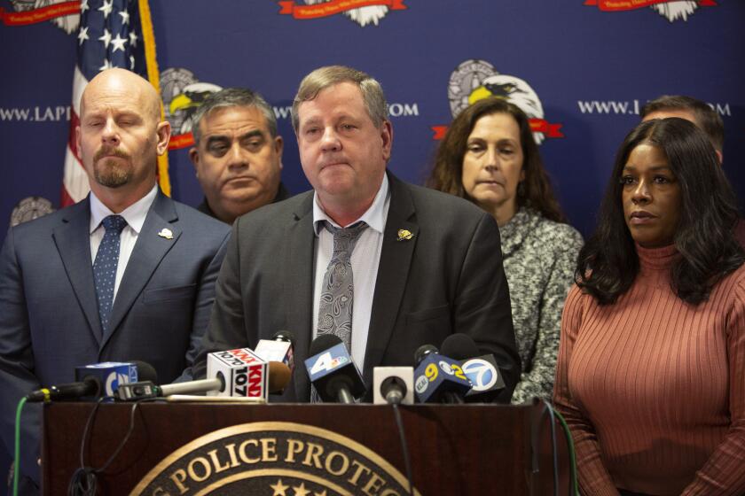 LOS ANGELES, CA - Wednesday, Dec. 4 Craig Lally, center, President of the Los Angeles Police Protective League, speaks during a press conference at the Los Angeles Police Protective League in downtown Los Angleles on Wednesday, Dec. 4, 2019. The Los Angeles Police Protective League Board of Directors will expressed their outrage over the allegation that an on-duty Los Angeles Police Department officer fondled a deceased female. If these allegations are found to be true and if there is any criminality involved, the Los Angeles Police Protective League will not defend the accused individual in any criminal proceedings. (Photographs by Gabriella Angotti-Jones/Los Angeles Times)