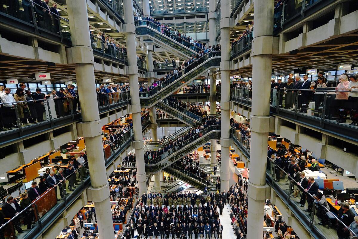 City workers attend a Remembrance Day ceremony at Lloyd's of London.