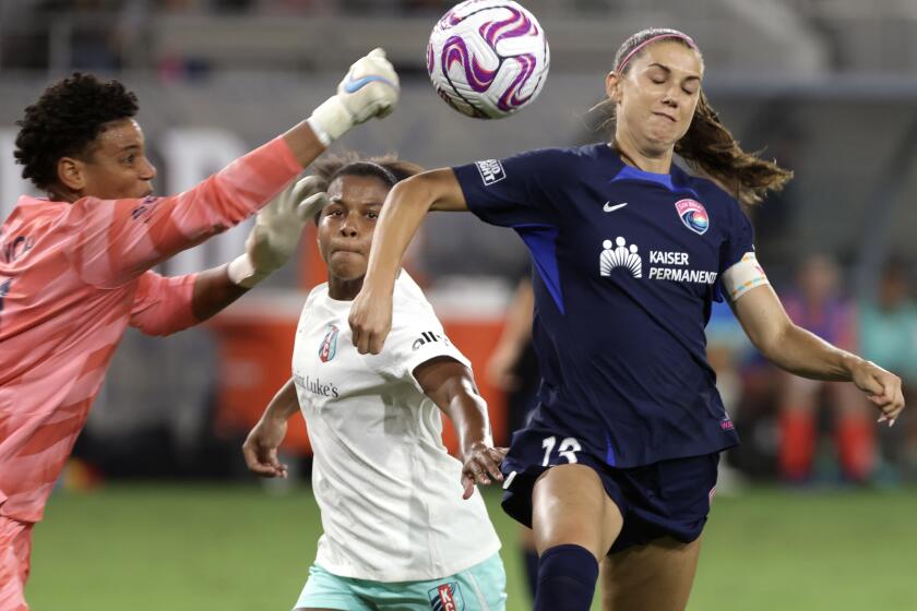 SAN DIEGO, CA - SEPTEMBER 16, 2023: The San Diego Wave's Alex Morgan, right, goes up in an attempt to head the ball into the goal as Kansas City Current's goal keeper Ad Franch blocks the ball with the Current's Elizabeth Ball reaching in during the second half at Snapdragon Stadium in San Diego on Saturday, September 16, 2023. (Hayne Palmour IV / For The San Diego Union-Tribune)