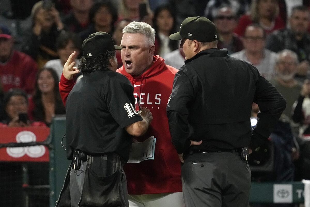 Angels manger Phil Nevin, center, argues with home plate umpire Phil Cuzzi.
