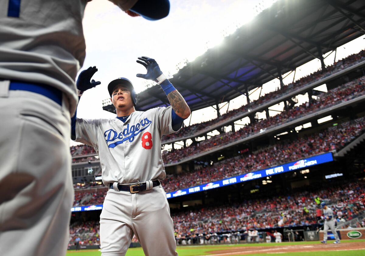 Dodgers shortstop Manny Machado celebrates after hitting a three-run home run against the Atlanta Braves in the seventh inning of Game 4 of the NLDS on Monday.