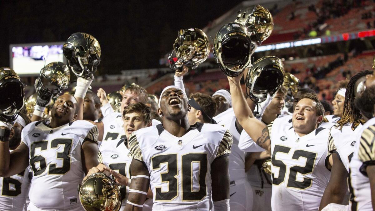 Wake Forest's Ja'Cquez Williams (30) celebrates with his team after defeating North Carolina State.