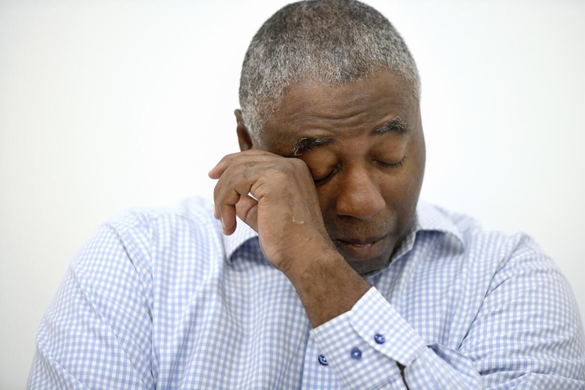 Charles Richardson, of Baltimore, wipes his eye while discussing his alleged abuse by a Catholic priest.
