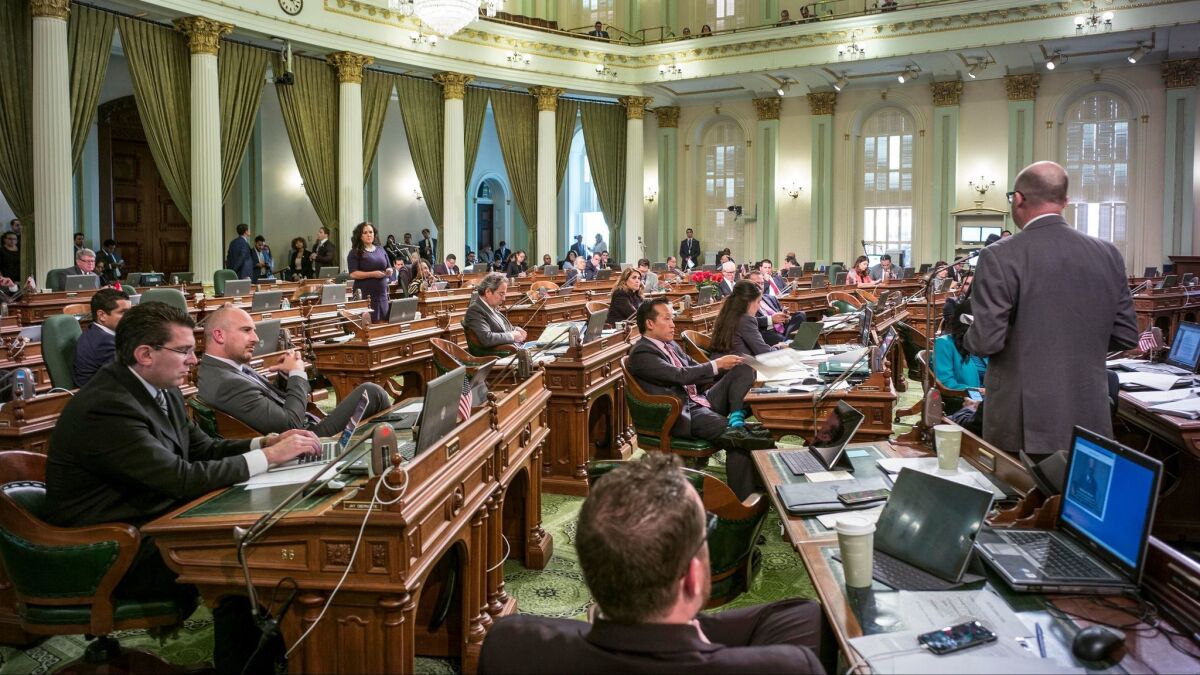 Assembly members debate proposals in their green-carpeted chamber on Friday, the last day of the legislative session.