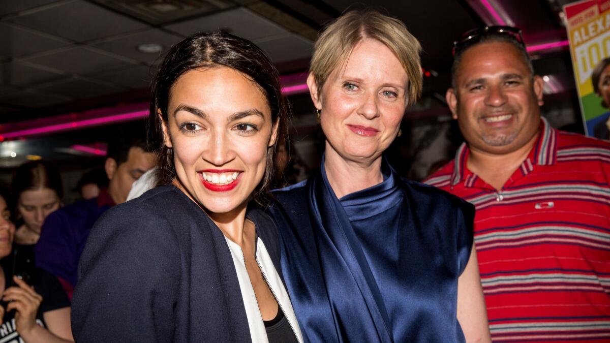 Progressive challenger Alexandria Ocasio-Cortez celebrates with New York gubenatorial candidate Cynthia Nixon at her victory party in the Bronx after upsetting incumbent Democratic Rep. Joseph Crowley on Tuesday.