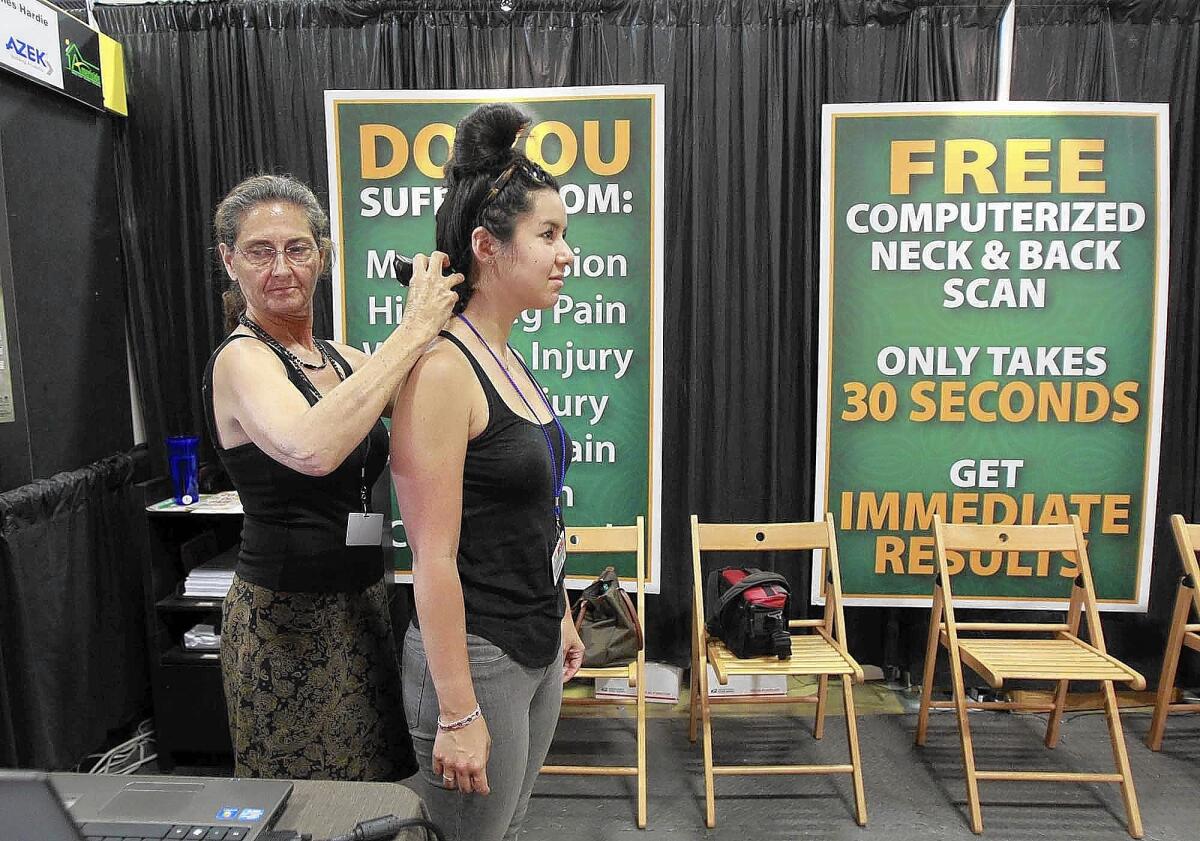 Daily Pilot reporter Jill Cowan gets a 10 minute massage from one of the staff members at the Relaxation Station at the OC Fair. Visitors can choose several self help and pampering activities from beauty to health at the OC Fair.