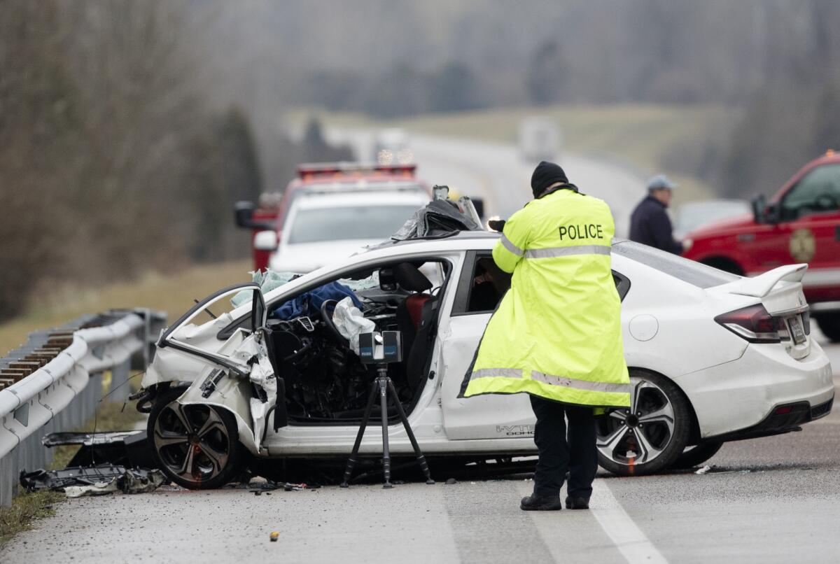FILE - Emergency crews work the scene of a fatal crash involving a charter bus and car on the AA highway in Campbell County, Ky., Jan. 25, 2020. Roadway deaths rose 7% during the first three months of 2022 to 9,560 people, the highest number for a first quarter in two decades, according to estimates by the National Highway Traffic Safety Administration. (Albert Cesare/The Cincinnati Enquirer via AP, File)