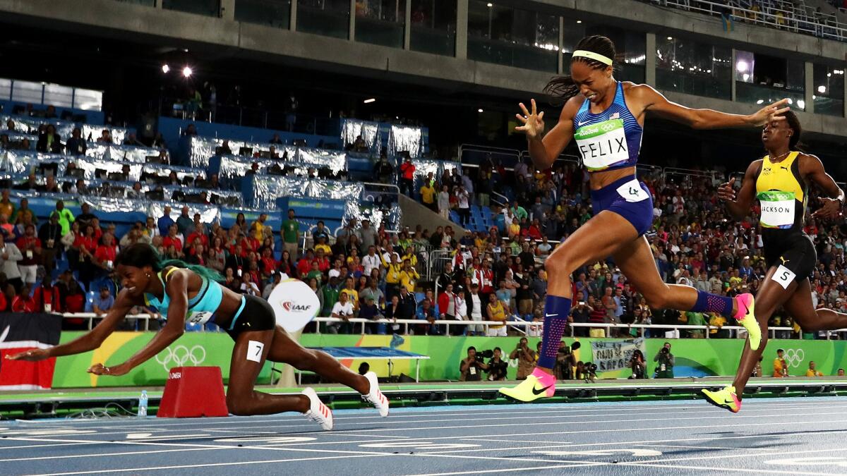 Shaunae Miller of the Bahamas dives over the finish line to win the gold medal in the women's 400 meters ahead of American Allyson Felix and Jamaica's Shericka Jackson on Monday.