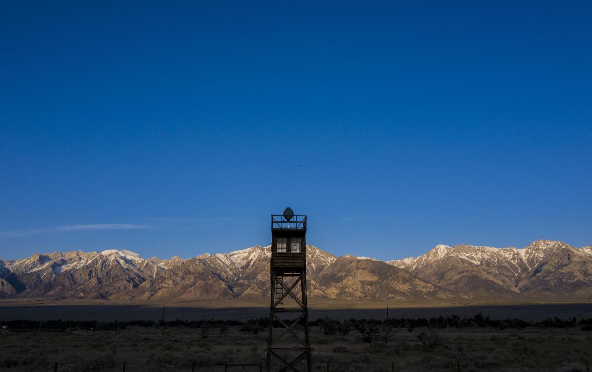 A tower in front of a mountain range