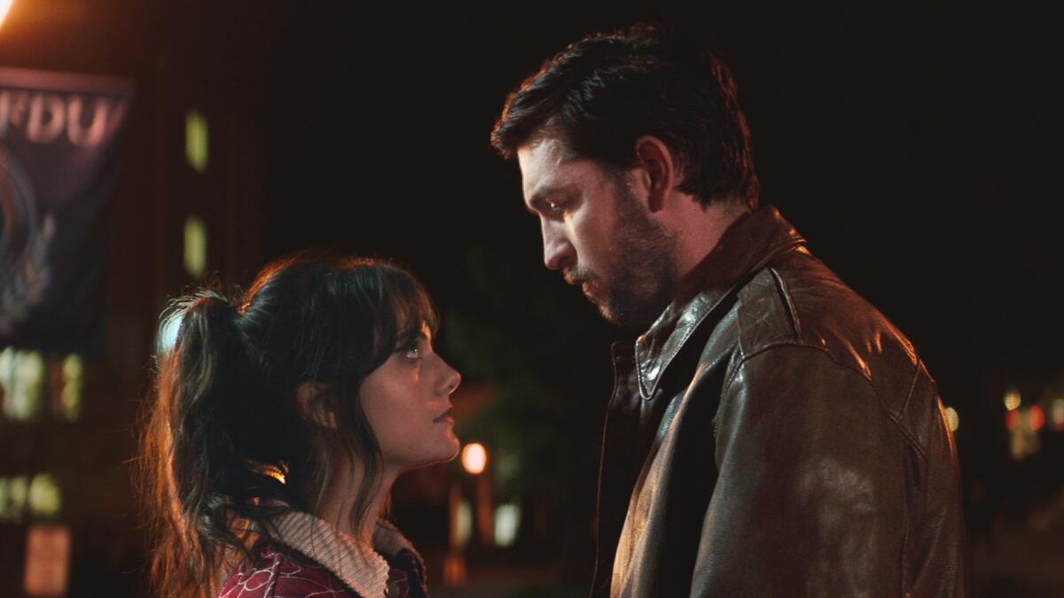 A woman looks up at a taller man.