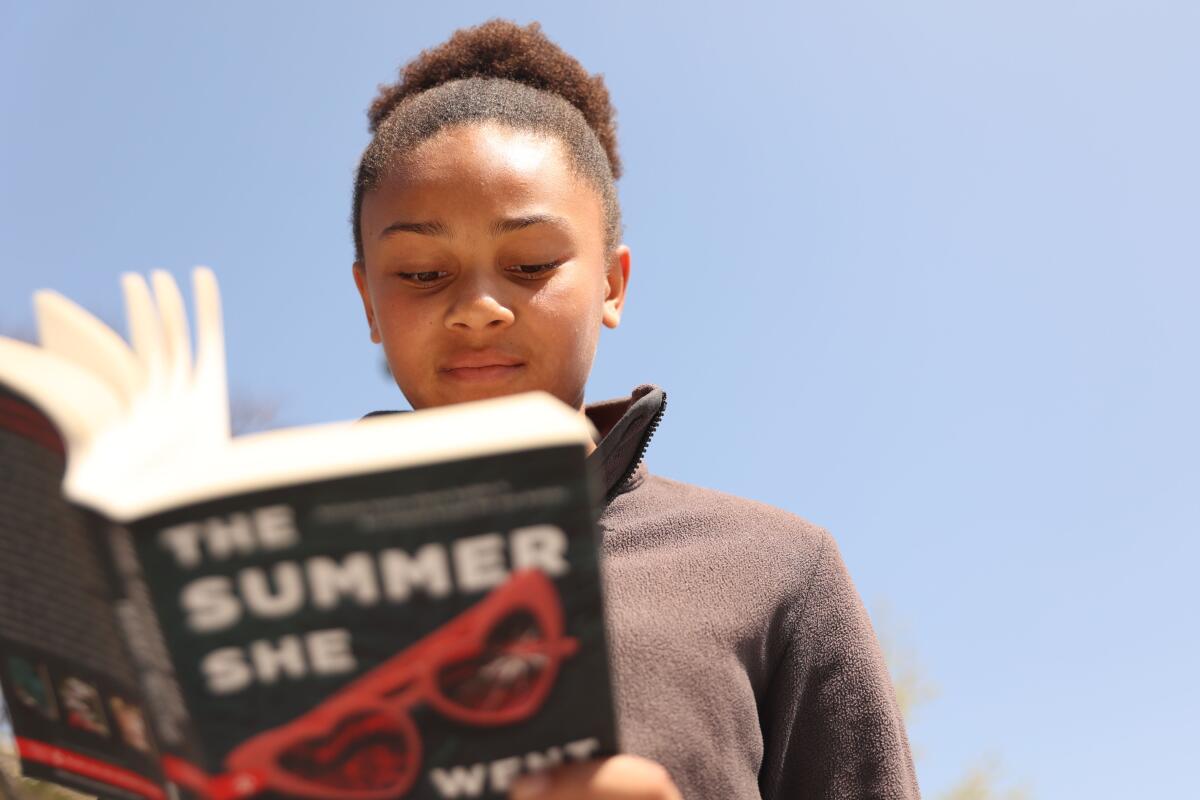 Karlie, 11, reads "The Summer She Went Missing" by Chelsea Ichaso.