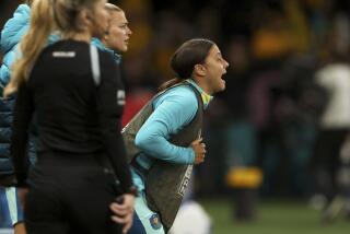 Australia's Sam Kerr shouts to her teammates from the sideline during World Cup match against Canada 