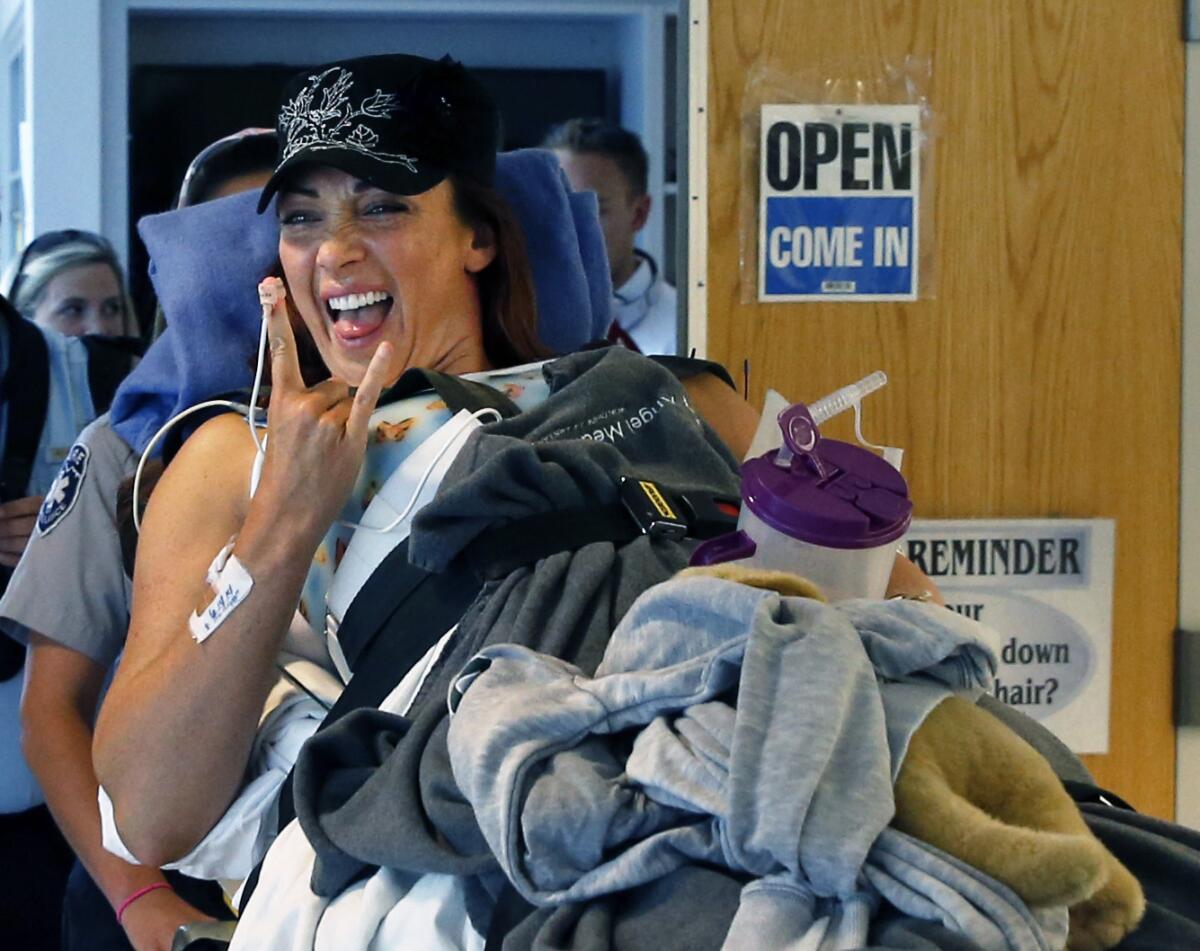 Former Olympic gold medal swimmer Amy Van Dyken-Rouen smiles after arriving at Craig Hospital in Englewood, Colo., on June 18.