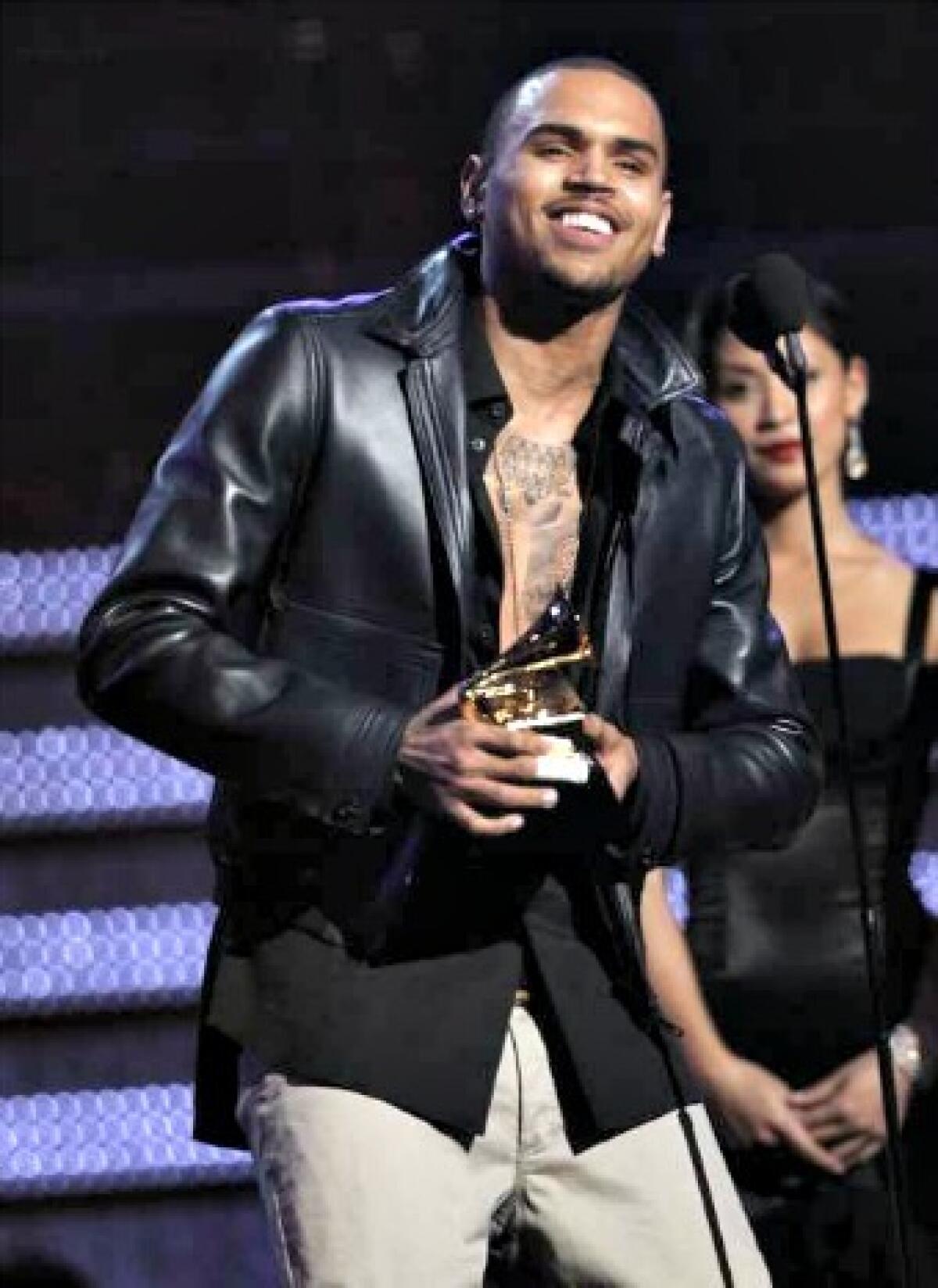 Chris Brown accepting the award for best R&B album for "F.A.M.E." during the 54th annual Grammy Awards in Los Angeles.