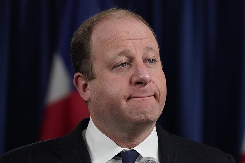 Colorado Gov. Jared Polis said he will continue to serve the state while isolating himself.