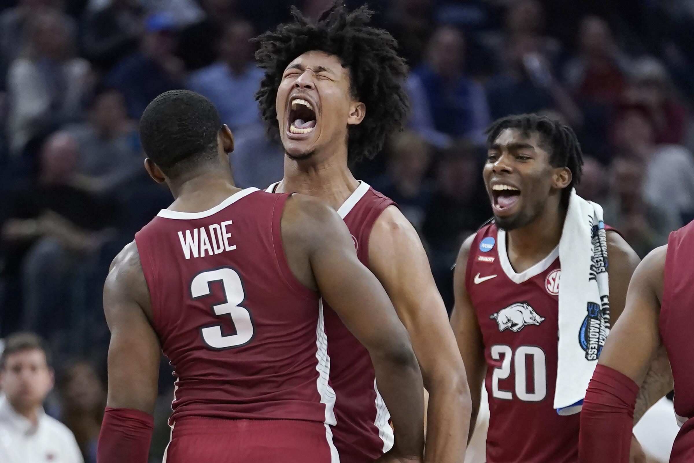 Arkansas forward Trey Wade celebrates with forward Jaylin Williams and forward Kamani Johnson.