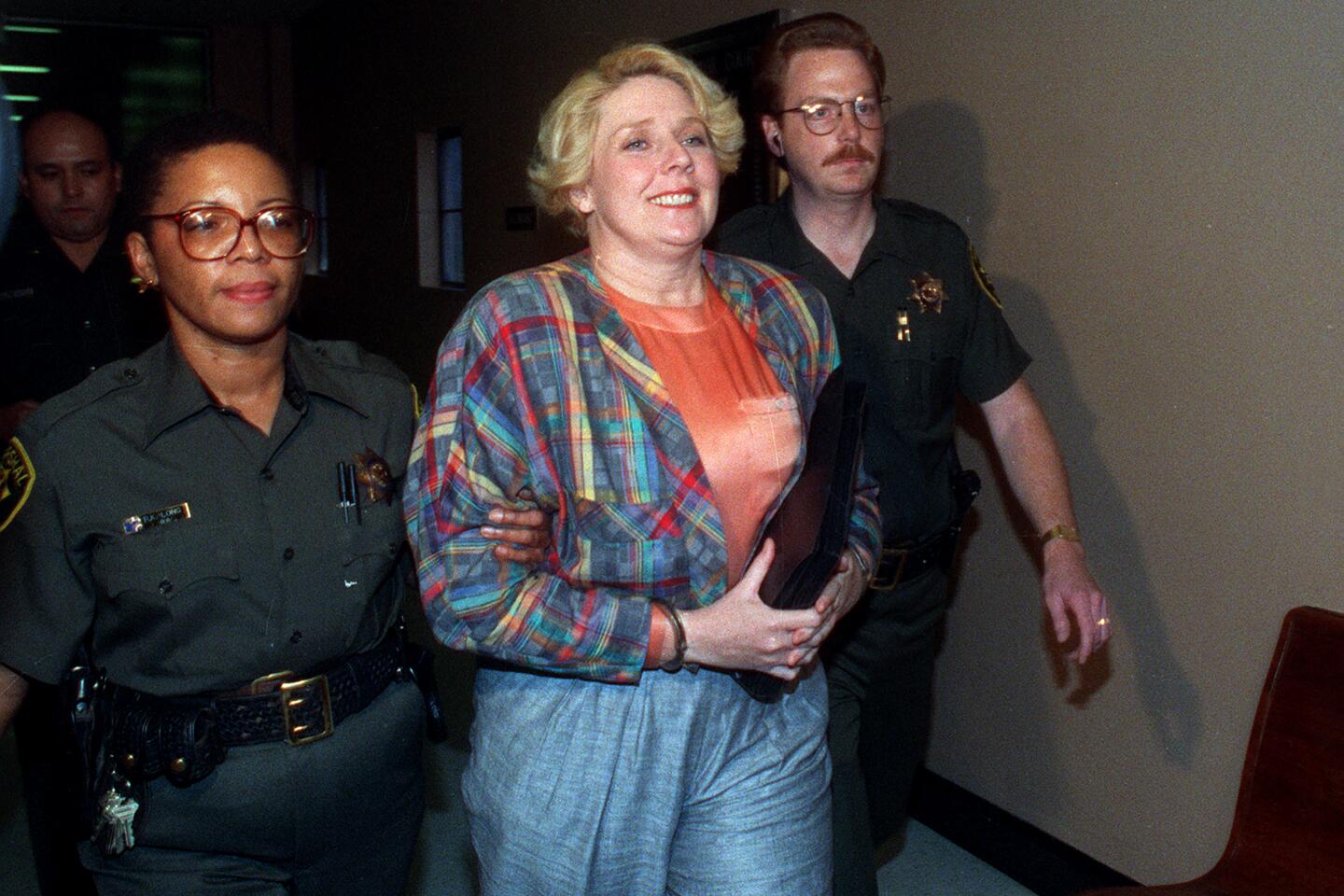 Elisabeth "Betty" Broderick is led by marshals through the hallways of the downtown San Diego County Courthouse on her way to a holding cell after being convicted of the murder of her ex-husband, Dan, and his new wife, Linda, on Dec. 10, 1991.