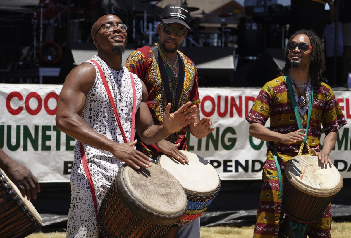 Performers play the drums during the entry procession at the Cooper Family Foundation's Juneteenth celebration
