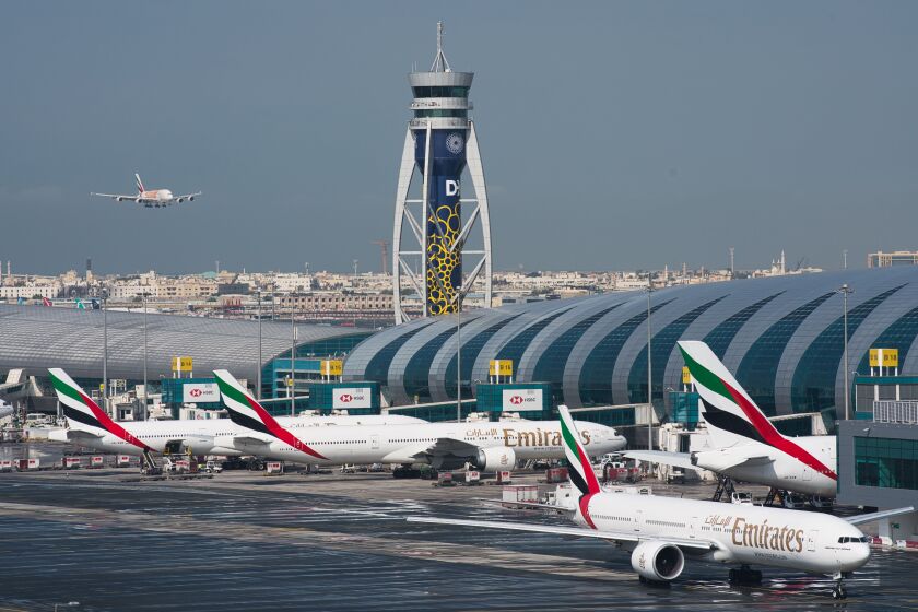 CORRECTS THE YEAR TO 2022, NOT 2021 - FILE - An Emirates jetliner comes in for landing at the Dubai International Airport in Dubai, United Arab Emirates, Dec. 11, 2019. Airlines across the world, including the long-haul carrier Emirates, rushed Wednesday, Jan. 19, 2022, to cancel or change flights heading into the U.S. over an ongoing dispute about the rollout of 5G mobile phone technology near American airports. (AP Photo/Jon Gambrell, File)