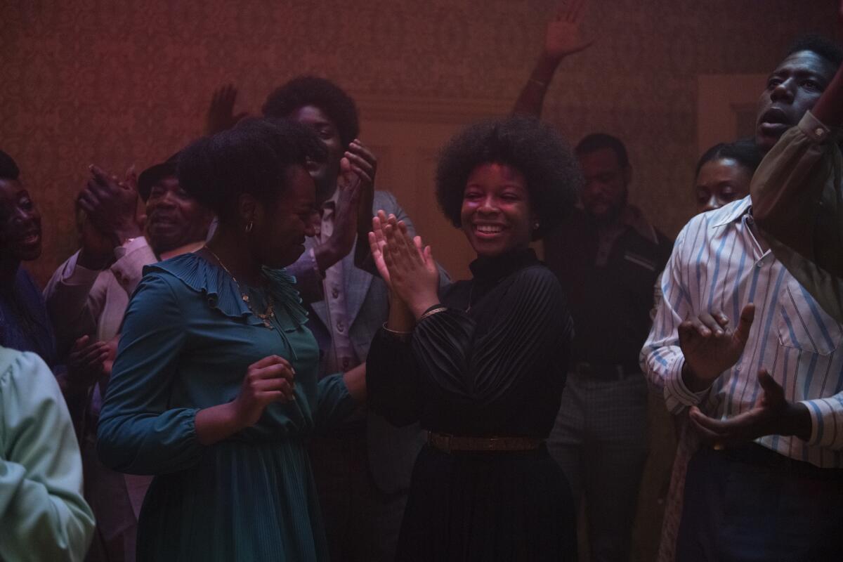 Partygoers dance and sing in a scene from Steve McQueen's "Lovers Rock."