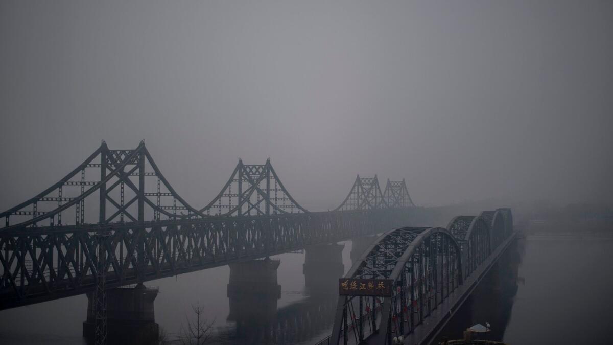 Fog shrouds the Friendship and the Broken bridges over the Yalu River connecting the North Korean town of Sinuiju and the Chinese city of Dandong on April 15, 2017.