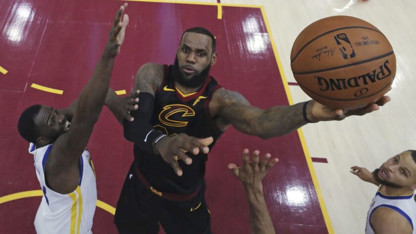 Cleveland's LeBron James drives against Golden State's Draymond Green during the first half of Game 3 of basketball's NBA Finals on June 6 in Cleveland. James will join the Lakers, who seem poised to make a big splash in free agency next off-season.