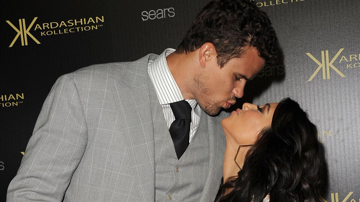 Kim Kardashian and Kris Humphries arrive on the red carpet of the Kardashian Kollection Launch Party on Aug. 17, 2011.