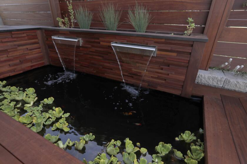 Kris and Dave Ethington of San Clemente are the grand prize winners of Orange County's 2018 California Friendly Garden Contest. A small koi pond with recirculating water highlights their rear patio deck made of oiled wood.