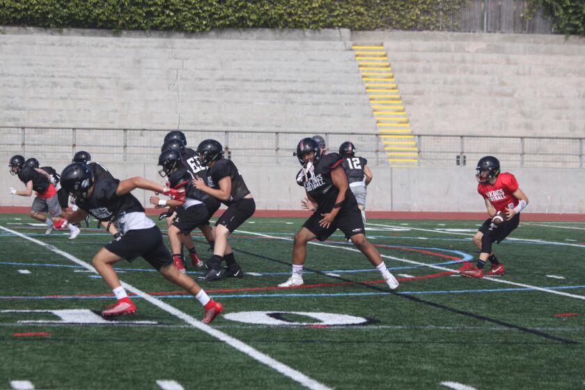 The La Jolla High School Vikings football team run drills during practice.