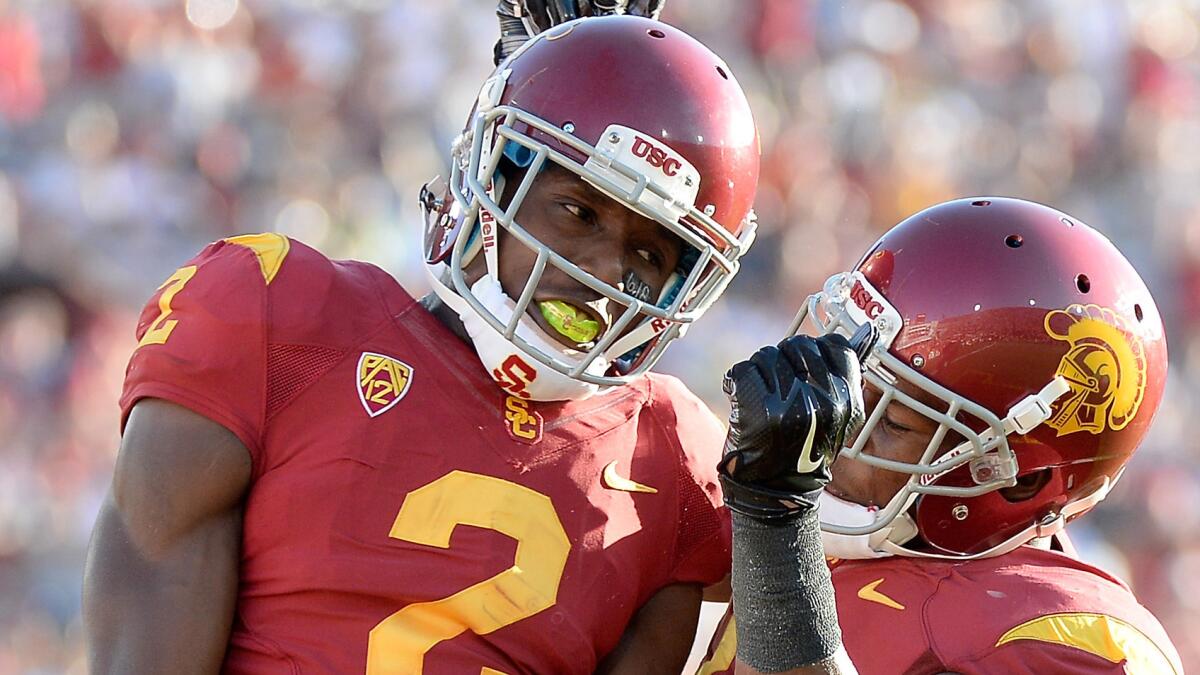 USC cornerback Adoree' Jackson, left, celebrates with teammate JuJu Smith after scoring a touchdown in the Trojans' season opener against Fresno State at the Coliseum on Aug. 30.
