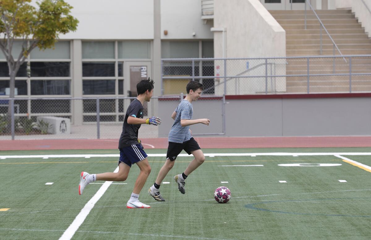 Two students practice soccer at Laguna Beach High School.