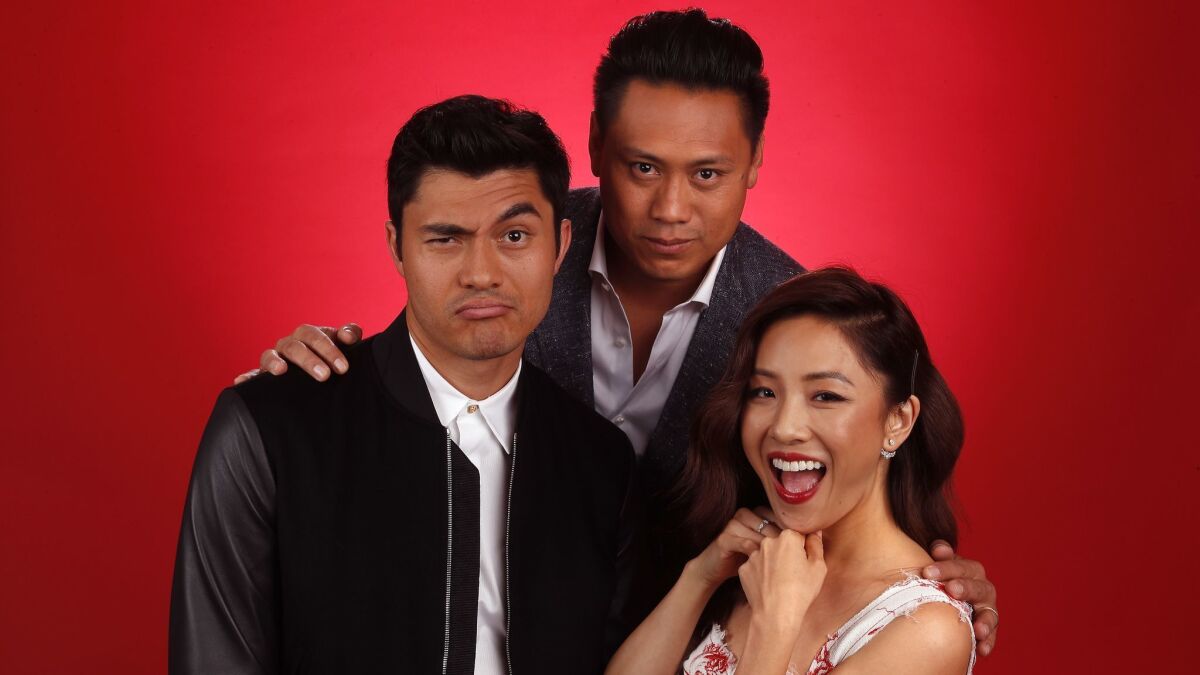 Jon M. Chu, center, director of the film, "Crazy Rich Asians," with lead actors Henry Golding, left, and Constance Wu.