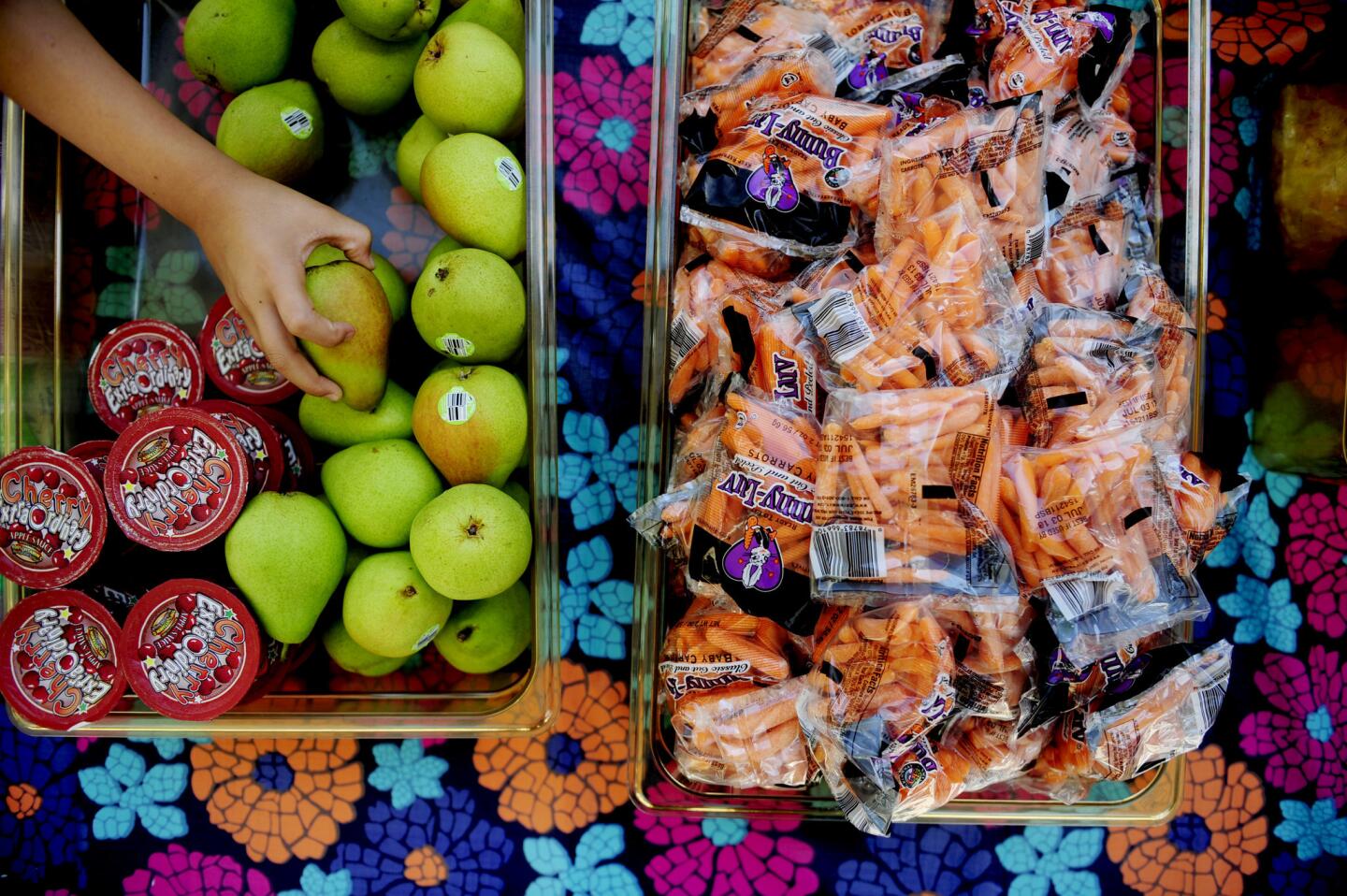 A student assembles lunch at Hollingworth Elementary School. Hollingworth feeds about 200 students and community members under age 18 every day during its six-week summer food program.