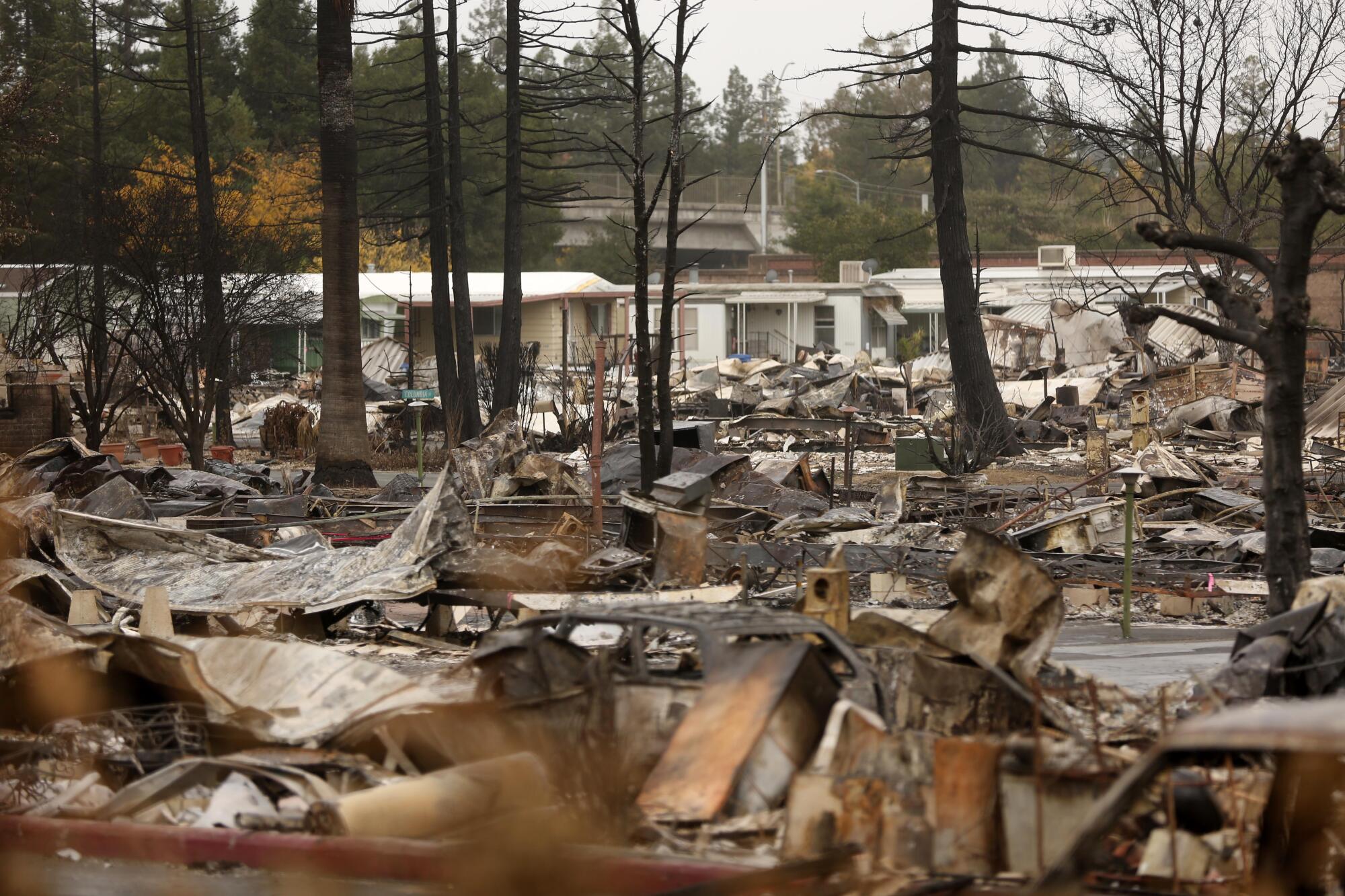 Burned debris covers most of a trailer park hit by fire.