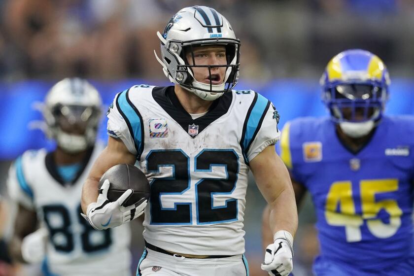 Carolina Panthers running back Christian McCaffrey (22) runs past Los Angeles Rams linebacker Bobby Wagner.