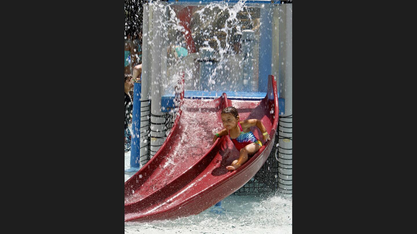 Jayla Peevyhouse, 3, of Burbank, goes down a watery slide at the Verdugo Aquatic Center in Burbank on a hot Friday, June 16, 2017. Temperatures rose to the mid 90's.