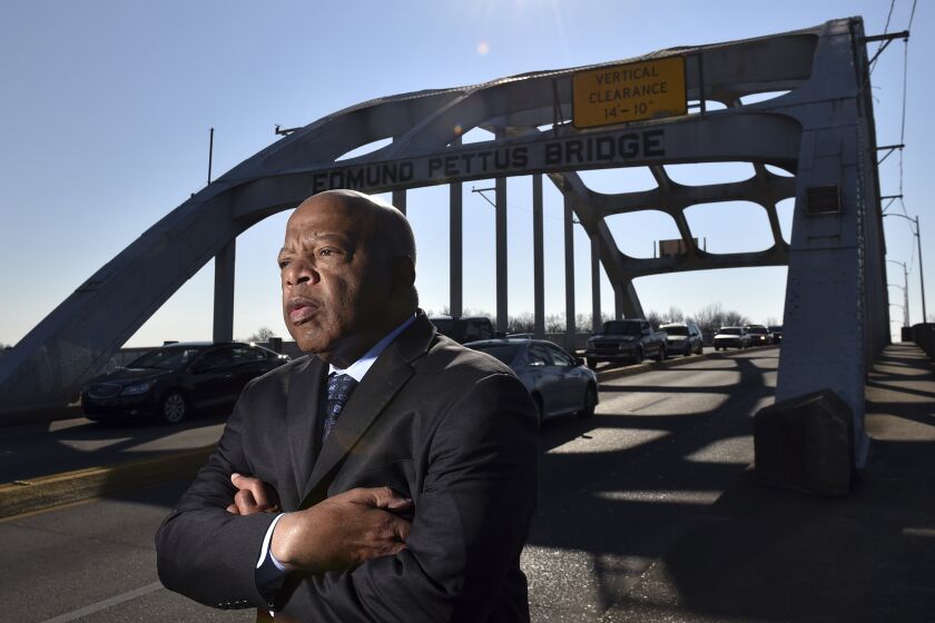 Congressman John Lewis on the Edmund Pettus Bridge in Selma, Ala., February 14, 2015. On March 7, 1965, Hosea Williams and John Lewis led 600 civil rights activists across the Edmund Pettus Bridge in a march for voting rights. Lewis had no idea the level of violence that awaited the group on the other side of the bridge. In what would become known around the country as as Bloody Sunday, state troopers and sheriff deputies used tear gas and clubs to break up the march. Leaving Lewis with a skull fracture and sending more than 50 others to the local hospital for treatment. (Brant Sanderlin/Atlanta Journal-Constitution via AP)