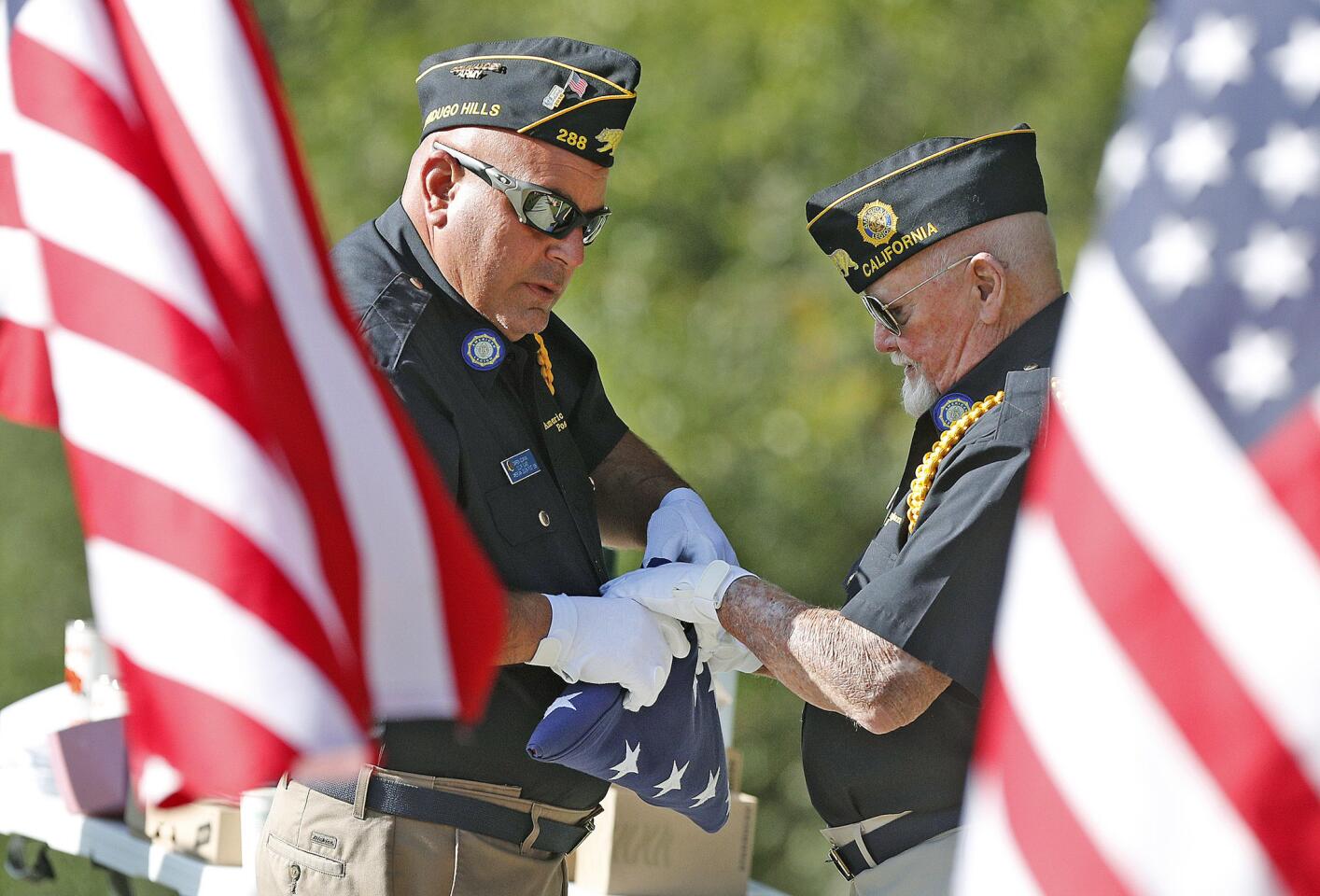 Color guard members and veterans Darren Azarian and Jack Wunderlich, with American Legion Post 288, work out the details for their part in a ceremonial U.S. Flag folding to recognize James Bauder at a Memorial Day service at Two Strike Park in La Crescenta at the Memorial Wall on Monday, May 28, 2018. The ceremony paid special recognition to recently found pilot James Bauder, missing since 1966 but found by a search crew in 2017.