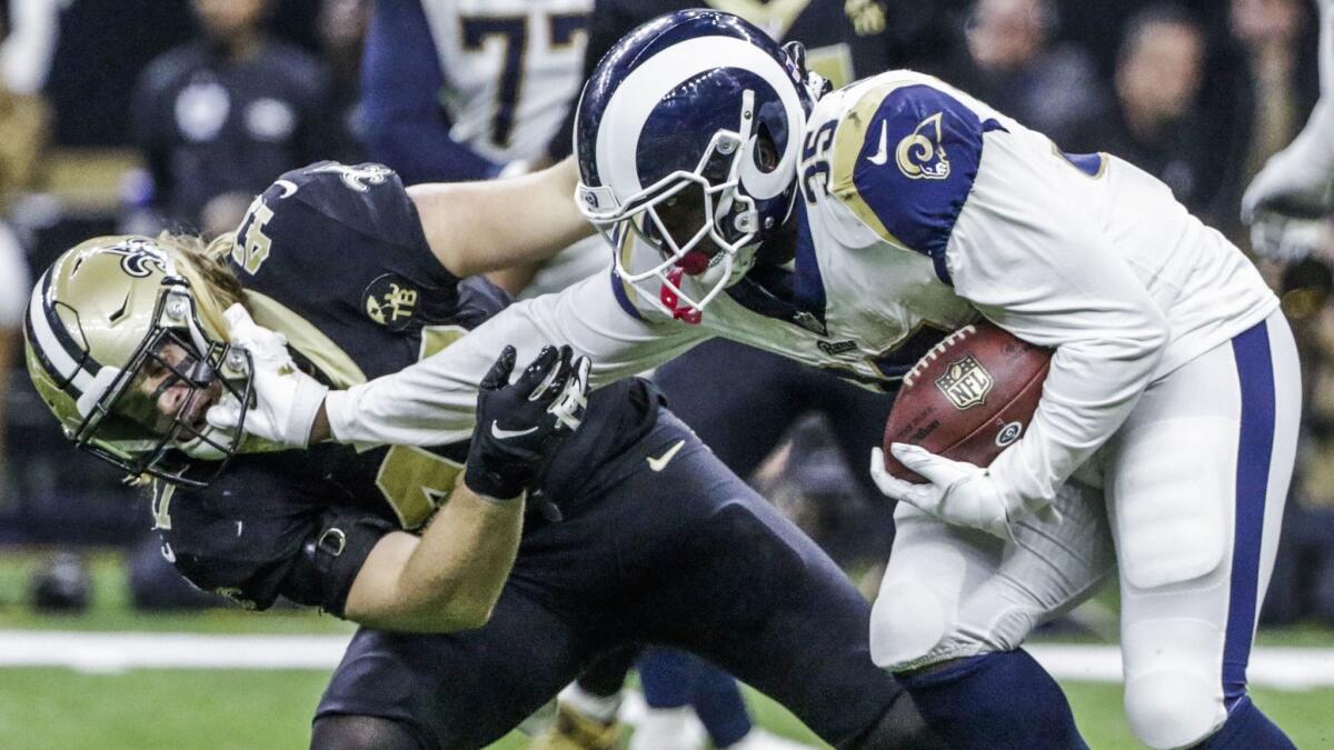 Rams cornerback Dominique Hatfield puts a hand to the face of Saints linebacker Alex Anzalone during Sunday's NFC championship game.