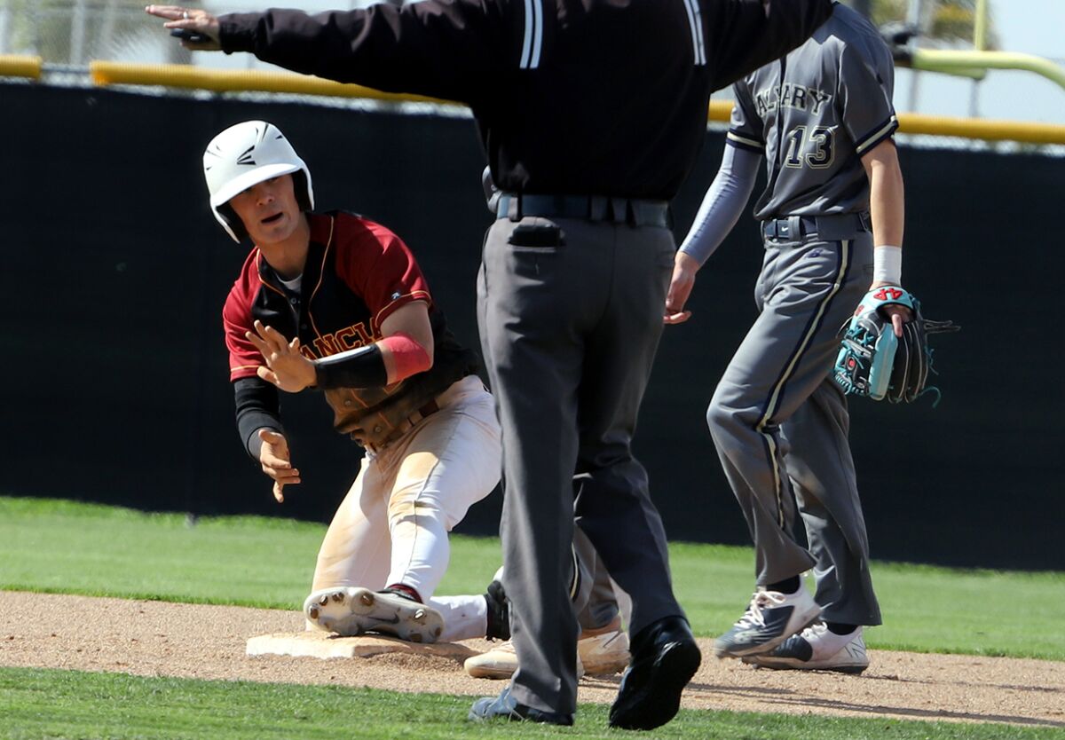 Estancia's Andrew Coyotzi (2) calls for time after sliding safe into second base against Calvary Chapel on Friday.