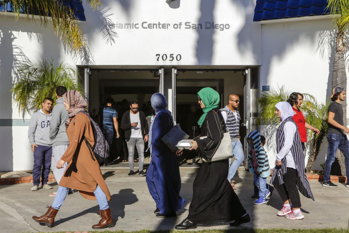 Muslims leave after prayers at the Islamic Center of San Diego. A hate crime on SDSU's campus and drawings of swastikas at UCSD have left the community on edge.