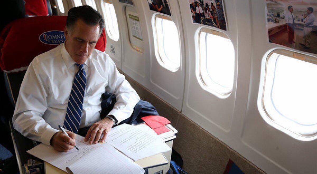 Mitt Romney works aboard his campaign plane Friday in Columbus, Ohio.