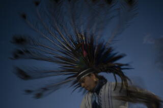 Mexica dancer in feather headdress performs